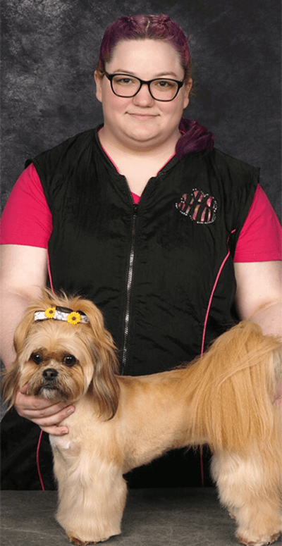 ashley drying off dog after grooming it