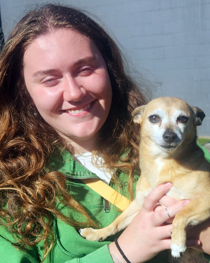 Meet Emily, a professional dog walker with Tailored Pet Services LLC in Everett, WA 98203, pictured smiling while holding a small tan dog. Emily provides personalized dog walking services focused on exercise, enrichment, and building lasting relationships with her four-legged clients. With a lifelong love of animals and a passion for outdoor activities, she enjoys getting to know each dog's unique personality and making every walk a positive experience.